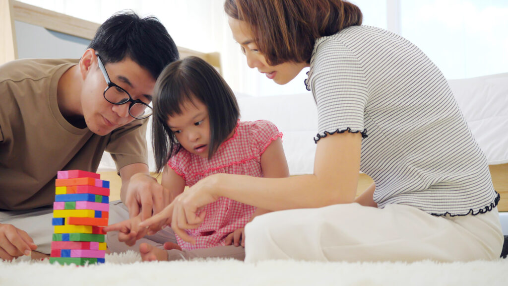 Happy family with mother, father and disabled daughter spending
